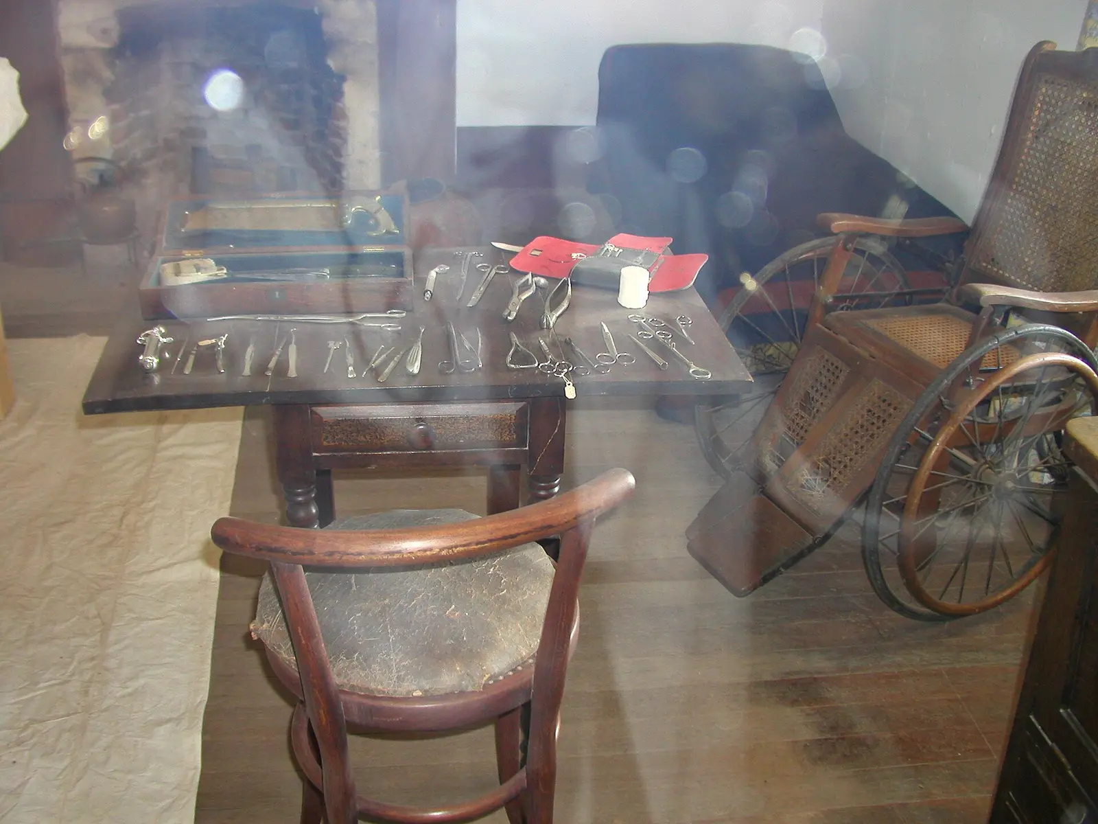 Peeking through the glass of the surgeon's work room at Fort Verde State Historic Park, we can see some tools of the trade