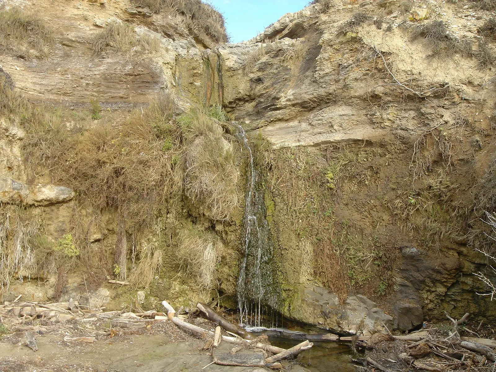 A waterfall whose water flows across the beach sands into the ocean — Crystal Cove State Park
