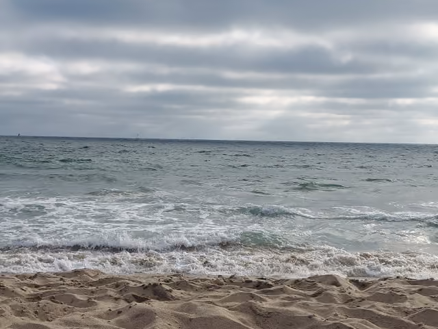 The Pacific Ocean and sand photographed on Dockweiler Beach