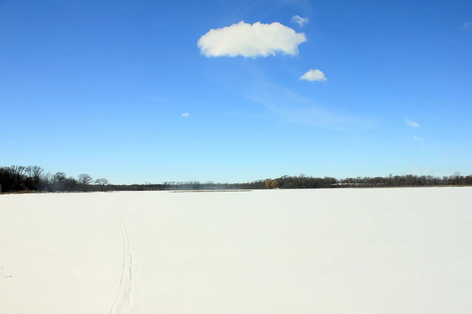 Lake Maria completely frozen in ice and snow in the winter inside of Lake Maria State Park, MN