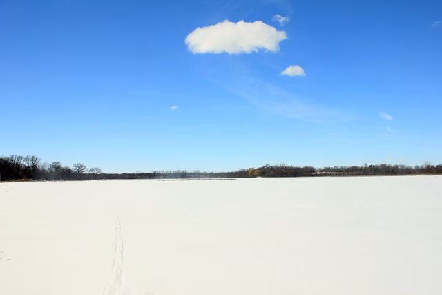 Lake Maria completely frozen in ice and snow in the winter inside of Lake Maria State Park, MN