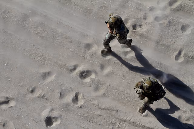 New Jersey Air National Guard Tactical Air Control Party Airmen from the 227th Air Support Operations Squadron rush towards a rope…