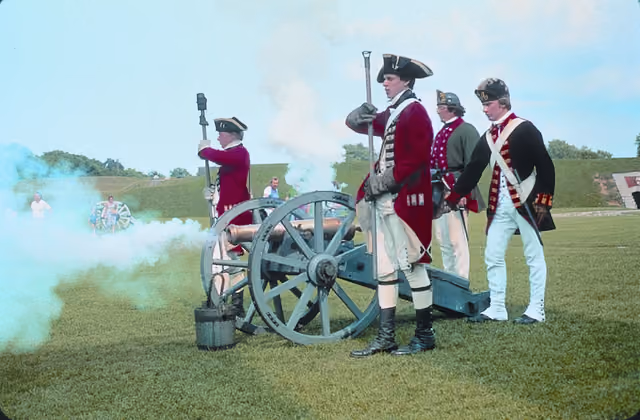 Scope and content: The original finding aid described this photograph as: Original Caption: Byway visitors peer through cannon smoke, as…