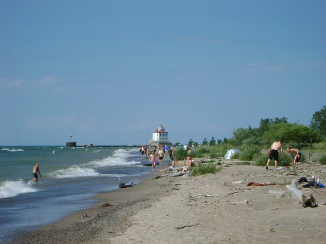 Headlands Beach at Lake Erie (Ohio, United States) with Fairport Harbor West Breakwater Light in the distance