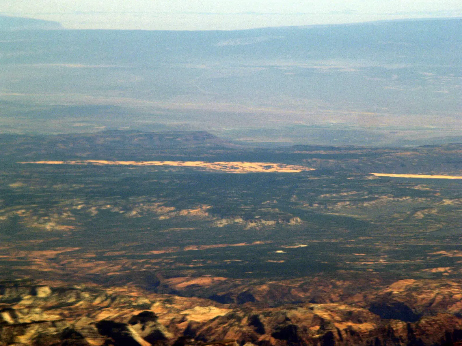 This is an aerial view of Coral Pink Sand Dunes Park with parts of Zion National Park in the foreground